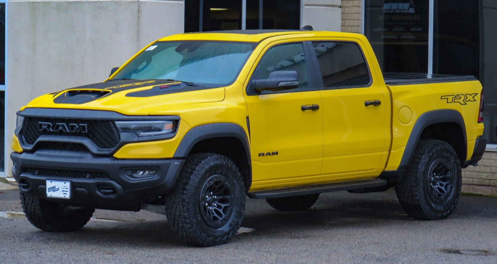 Yellow RAM TRX dealership photo before AI background replacement