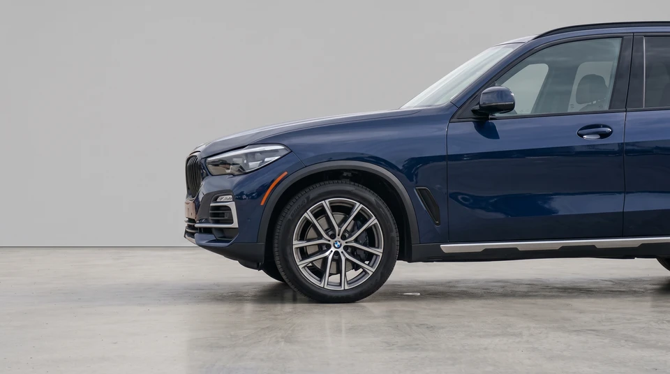 Blue BMW X5 after CarPixAI background processing in a clean neutral dealer studio