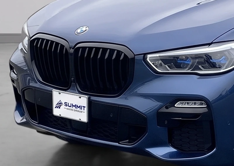 BMW with an uploaded Summit Auto Group logo applied inside the existing license plate face