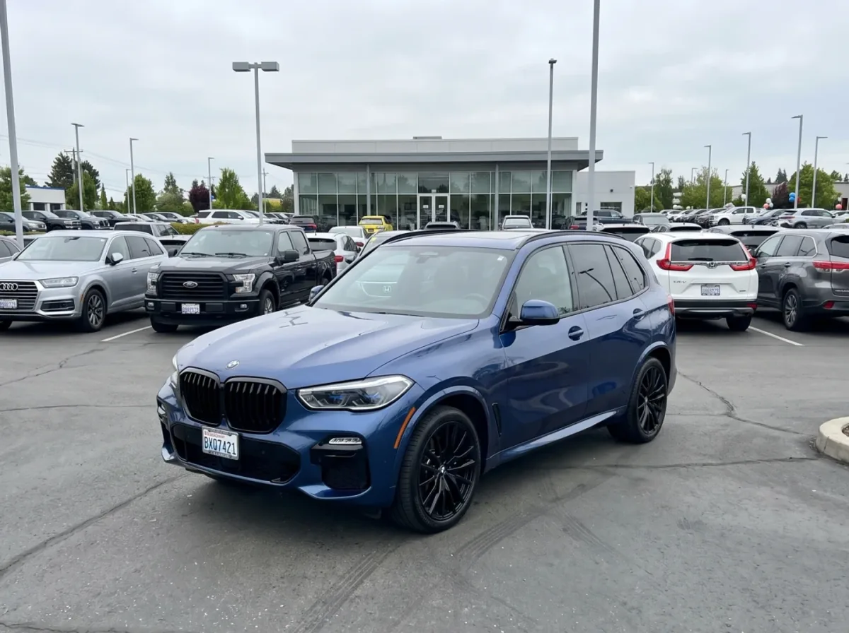 BMW X5 inventory photo on a crowded dealership lot before CarPixAI processing