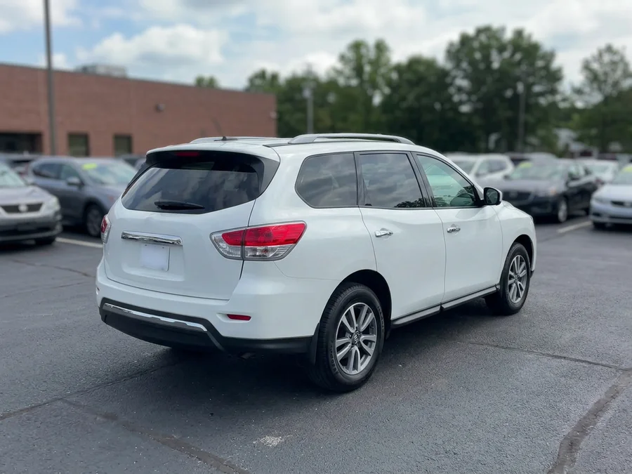 Example rear three-quarter car listing photo showing rear bumper, tail lights, side, and full vehicle